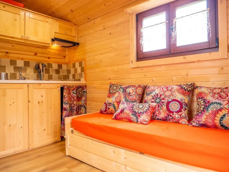 Interior of the red wagon at Domaine de la Trille, living area and fitted kitchen